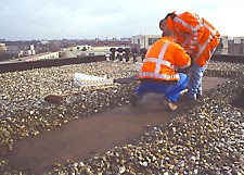 first gravel is removed with broom to expose bitumen for reliable and stable frame placement